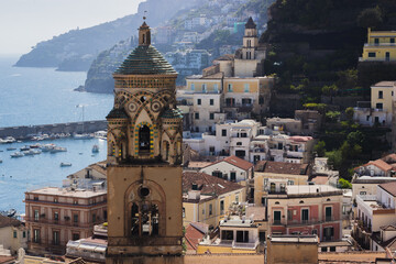 A dramatic view of the Amalfi Cathedral’s ornate dome among closely packed historic buildings...