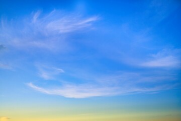 Sky Replacement evening sky with a low warm horizon and thin waves of clouds.