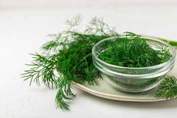 Dill on wooden background. Fresh organic greens. Dill plantation. Cut dill leaves. Bunch of spring...