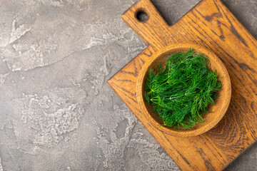 Dill on wooden background. Fresh organic greens. Dill plantation. Cut dill leaves. Bunch of spring...