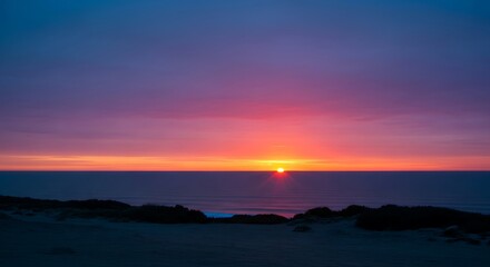 Obraz premium Serene Seascape Sun's Descent Into the Ocean's Embrace Under a Colorful Twilight Sky