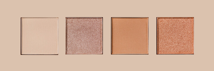 Fototapeta premium Closeup view Neutral Eyeshadow Palette with Matte and Shimmer, beige brown with golden shimmer shades. Top view of eyeshadow refills, Swatches powder eyeshadow or highlighter, cosmetic beauty, makeup
