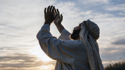 Muslim man praying. Muslim man prays raising his hands to the sky. 