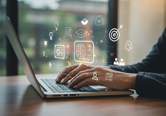 Focus on future skills: a person at a laptop with a digital overlay representing intelligence and achievement.