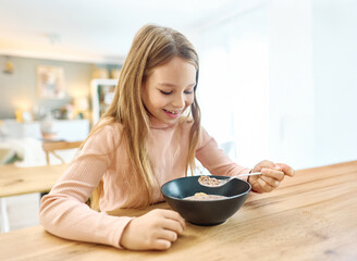 Portret of teen girl having fun eating breakfast in kitchen © Lumos sp