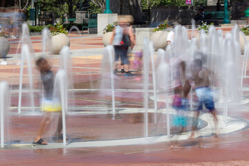 Motion blur shows kids playing in Centennial Olympic Park fountain