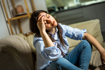 Depressed Young Woman Sitting Alone in Her Living Room