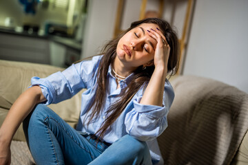 Depressed Young Woman Sitting Alone in Her Living Room