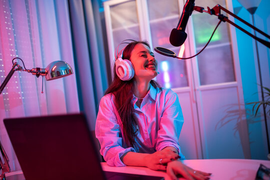 Young Woman Recording Her Podcast in LED-Lit Room