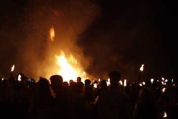Summer festival at night with bonfire and fireworks