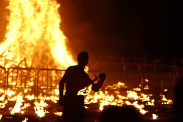 Summer festival at night with bonfire and fireworks