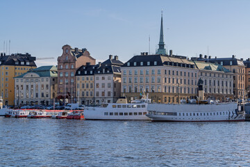 Historic Gamla Stan waterfront in Stockholm with ferries and church spire