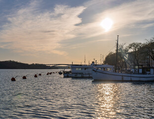 Sunset over Stockholm waterfront with anchored boats and buoys