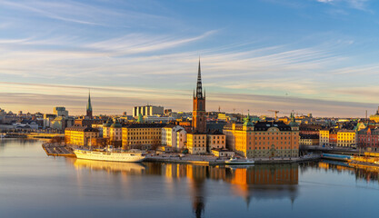 Historic buildings and Riddarholmen Church reflecting in Stockholm waters