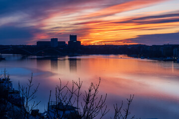Dramatic sunset over Kungsholmen with bridge and city silhouette
