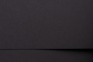 Black designer paper texture, minimalistic backdrop with geometric lines and deep shadows. Premium