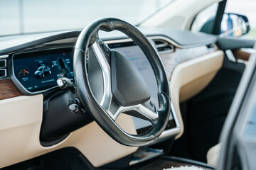 Detail shot of a white and black highend car interior with digital instruments and steering wheel...