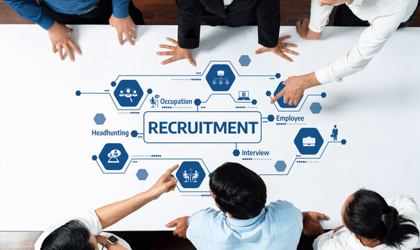 A diverse team collaborates on recruitment strategy in a modern office setting, analyzing graphics related to occupation, employee roles, and interview processes for effective hiring. Amity - Powered by Adobe