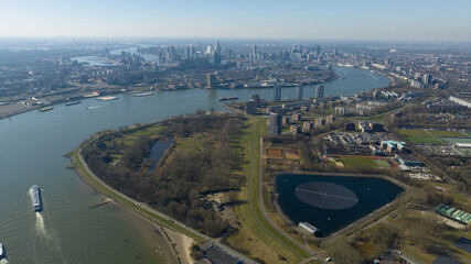 city view on Rotterdam skyline from a distance, SOuth Holland, The Netherlands, Nieuwe Maas river, solar panel on water. Aerial photo