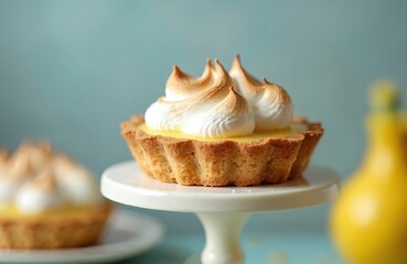 Lemon meringue tart on white cake stand. Traditional French and Italian dessert pastry with lemon custard filling topped whipped meringue. Homemade baked sweet food, delicious dessert.