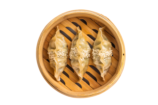 Steamed Korean dumplings with pork meat and vegetables in bamboo steamer isolated on white background. top view