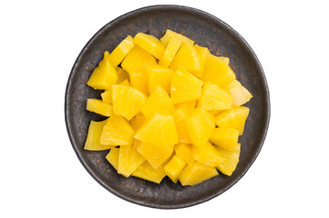 Pineapple chunks slices in a plate isolated on white background. top view