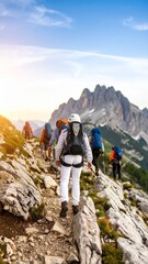 Fototapeta premium Hiking Group Ascending Mountain Trail at Sunrise.