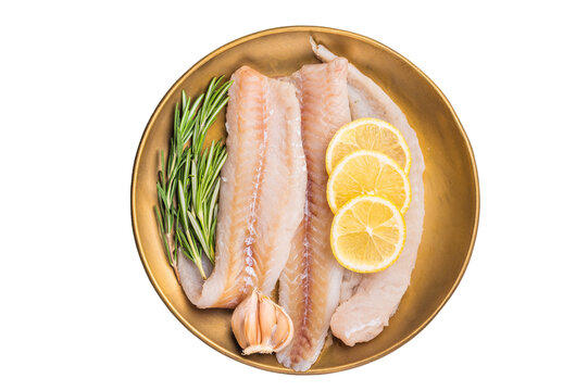 Pollock sea fish fillets, raw whitefish on a plate with herbs and lemon isolated on white background. top view