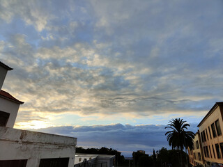 The sky is cloudy and the sun is setting