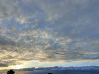 The sky is cloudy and the sun is setting