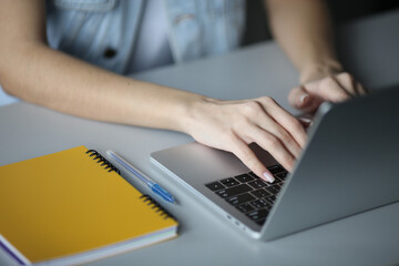 Female hands working on a laptop, close-up. Business, technology, internet and networking concept.