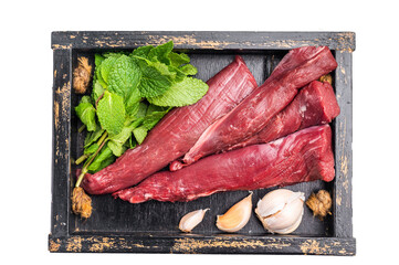 Mutton tenderloin fillet meat, raw lamb in wooden tray with herbs isolated on white background. top...