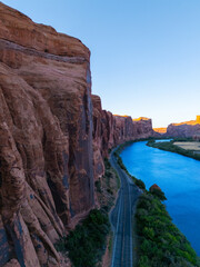 Beautiful Colorado River Through Red Desert Landscape With Towering Sandstone Canyon in Moab Utah at Potash Road Scenic Highway