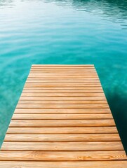 Fototapeta premium Wooden pier extending into the water. the pier is made of light-colored wood planks and is rectangular in shape. the water is a beautiful turquoise color and is calm and still.