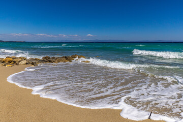 Turquoise sea and gentle surf on the Aegean coast