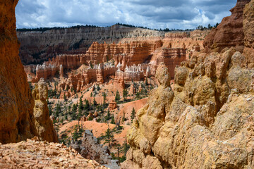 Looking out from the Queens Garden Trail at red rock hoodoo formations in Bryce Canyon National...