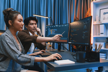 IT developers discussing with point to intelligent website development coder system running data...