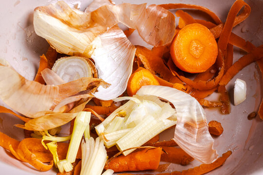 Peels from vegetables, peels from onions, carrots in a bowl. Food waste. Disposal of household food waste