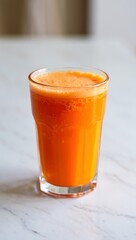 Fresh Orange Carrot Juice in Glass on Marble orange juice