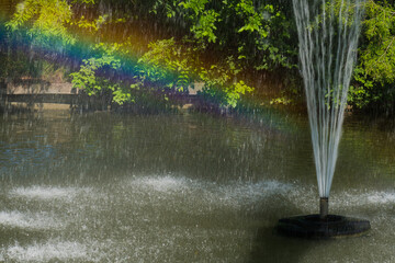 A Park Sparkling Fountain is Casting an Incredibly Beautiful Rainbow on a Warm Summer Morning