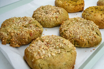 Sesame seed-coated savory biscuits freshly baked and arranged on a tray, ready for tasting.