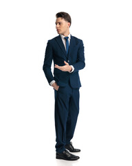 elegant young bussinessman in navy blue suit turning back and asking questions