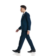 side view of confident businessman looking to side and walking
