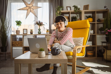 Woman sit at home use laptop computer to watch movie have video call