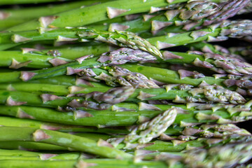 Close-up of fresh organic asparagus, showcasing its vivid green tones and crisp texture. Ideal for...