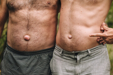Photograph, portrait of a family of adult men, two people, father and son, with large umbilical...