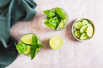 Spa spritz with cucumber, lime and basil in glasses on the table top view