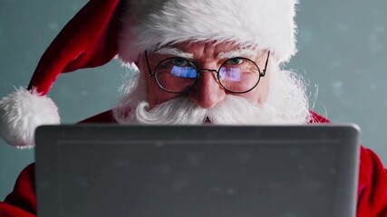 Happy Santa Claus wearing costume using laptop computer close up. Merry Christmas, ecommerce, website,xmas time holiday, online shopping sale concept,4K - Powered by Adobe
