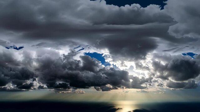 Dramatic storm clouds above a still ocean with shimmering sunlight piercing the dark sky, creating a powerful, serene atmosphere.