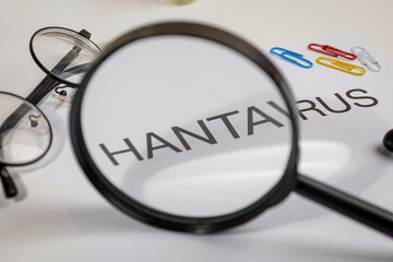 Hantavirus Alert Paper with Magnifying Glass on Doctor’s Desk – Medical Surveillance Scene